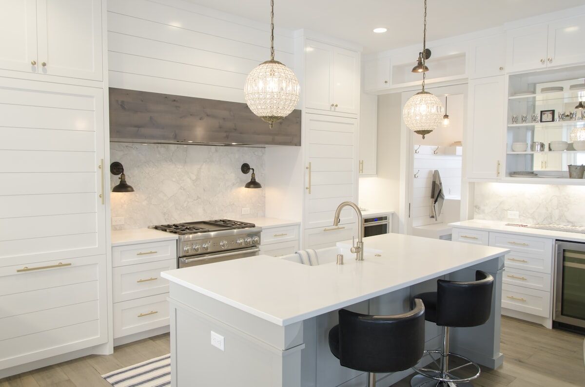 Modern white kitchen with a large island and pendant lighting